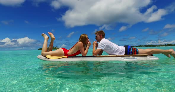 Fun couple in love dating on vacation live the dream on beach on paradise white sand 4K background