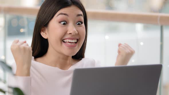 Asian Girl Winner with Laptop Playing Online Video Game Wins Betting Lottery Goals Financial Grows