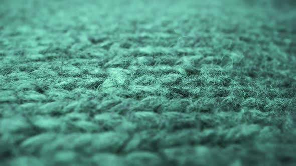 Extreme detail view of sheep wool cloth texture flowing in macro dolly shot.