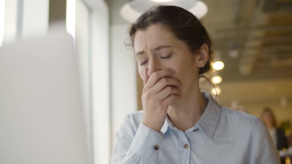 Young Sick Woman Coughing and Feeling Unwell Working with Laptop in Office
