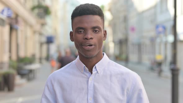 African Man Talking on Online Video Call Outdoor