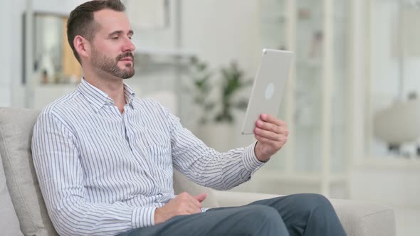 Cheerful Young Man Doing Video Chat on Tablet 