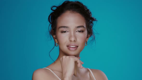 Pretty Afro Girl Posing and Touching Her Face on the Blue Background, Beautiful Female with Dark