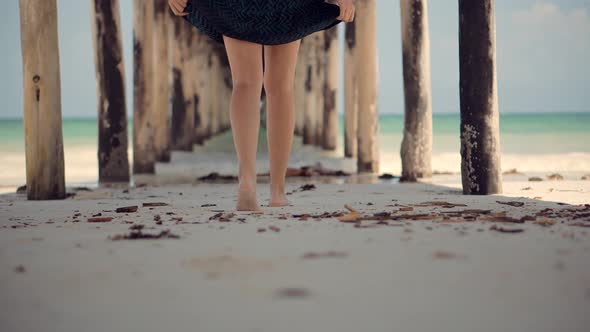 Summer Holiday Travel Vacation Adventure. Tourist Girl Walking On Beach. Tanned Woman In Dress.