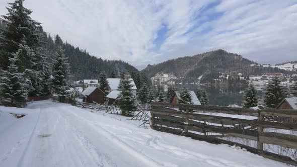 Snowy road leading to a mountain village