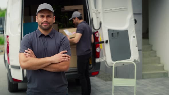 Video portrait of delivery man standing next to moving van. Shot with RED helium camera in 8K.