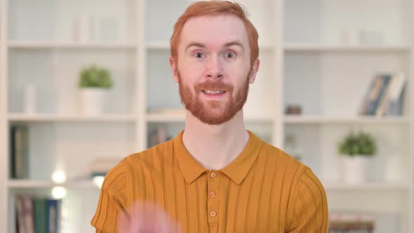 Portrait of Appreciative Redhead Man Doing OK Sign 