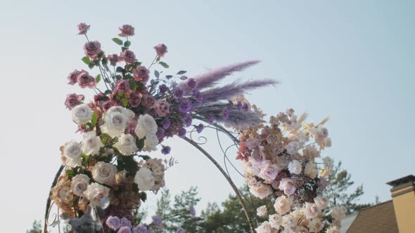 Medium Shot View of Wedding Floral Decorations of Flowers in Pastel Faded Colors Slow Motion Outside