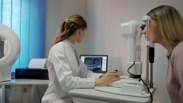 The Ophthalmologist Examines the Patient's Eye and Then Looks Into the Camera