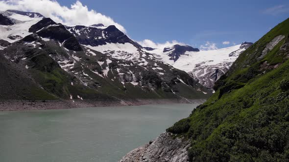 Peaceful Water Of Stausee Wasserfallboden Reservoir With Snow Mountains In Kaprun, Austria. - Aerial