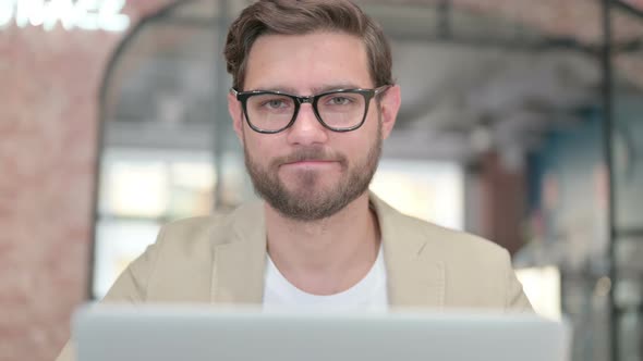 No Gesture By Head Shake By Man with Laptop