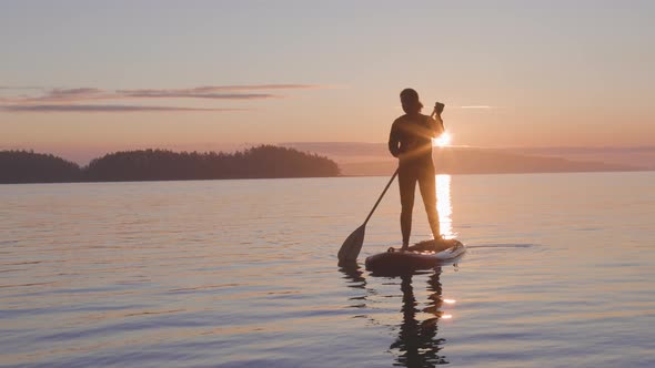 Adventurous Caucasian Adult Woman on a Stand Up Paddle Board