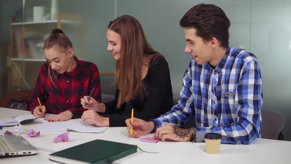 Group of Young Creative Workers in a Creative Start Up Work Environment Holding a Project Meeting in