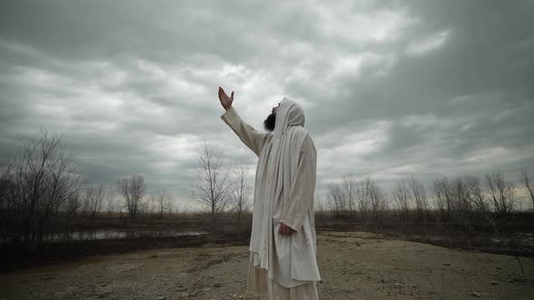 Religious Man Raises His Hand Praying And Worshipping