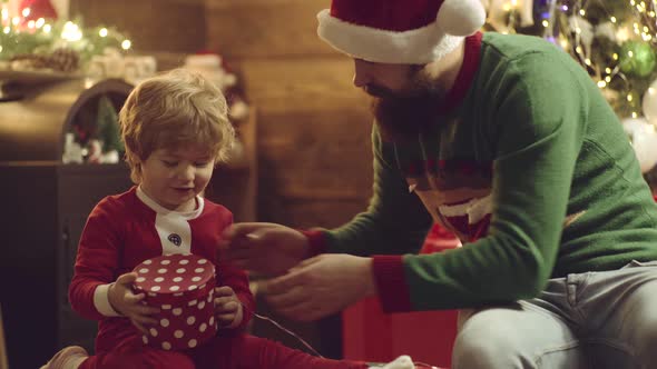 Happy Small Kids with Father in Santa Hat Open Present Gift and Have a Christmas. Thanksgiving Day