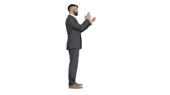 Businessman clapping hands impressed by something on white