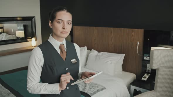 Female Hotel Manager with Tablet in Hotel Room