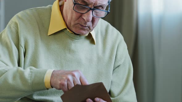 Portrait Old Man Ecstatic Grandpa with Glasses Sits at Home Indoors Receives Envelope Letter