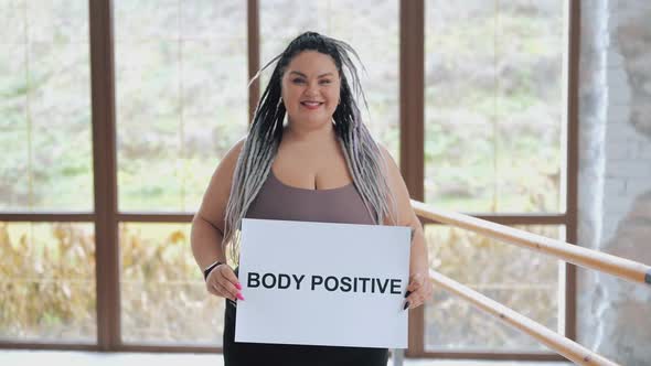 Happy Fat Woman in Underwear with Drearlocks Holding Body Positive Poster  I Love Myself