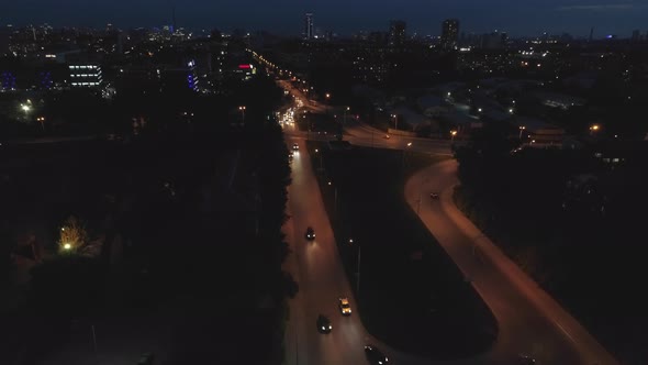 Aerial view of the streets of the city at night with Roundabout road junction 13