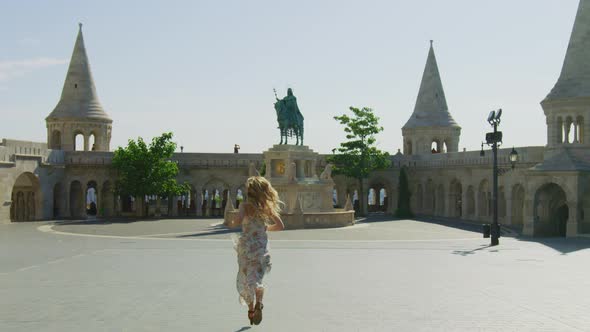 Woman running towards St. Stephen statue