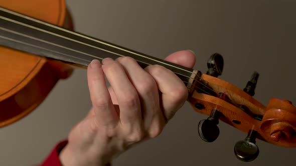 Violin in Hands of a Young Female Violinist During Music Performance