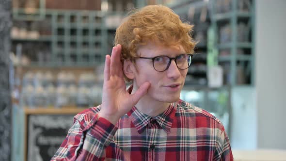 Young Redhead Man Listening Carefully