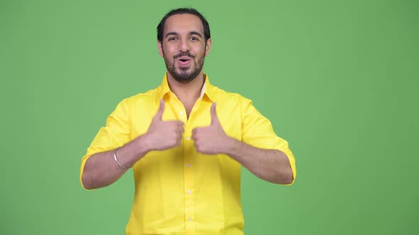 Young Happy Bearded Indian Businessman Looking Excited While Giving Thumbs Up