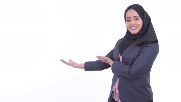 Happy Young African Muslim Businesswoman Talking While Showing To the Back