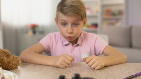 Excited Male Kid Taking Joystick From Table, Playing Video Game, Entertainment