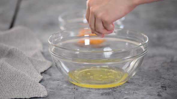 Cooks Hands Separate the Egg White From the Yolk. Close Up