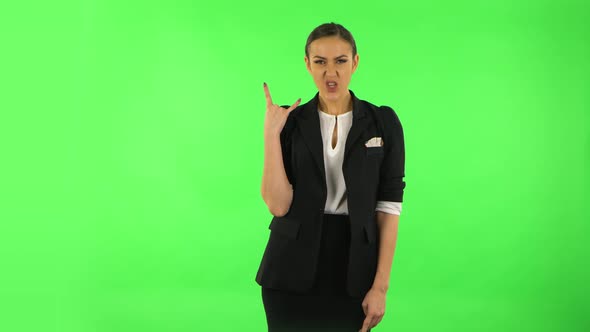 Female Making a Rock Gesture, Enjoying Life and Laughing. Green Screen