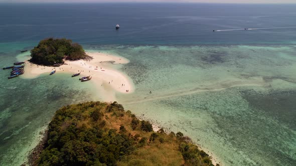 aerial drone circling Thale Waek Island in Krabi Thailand as mass tourism overcrowds the sandbar in