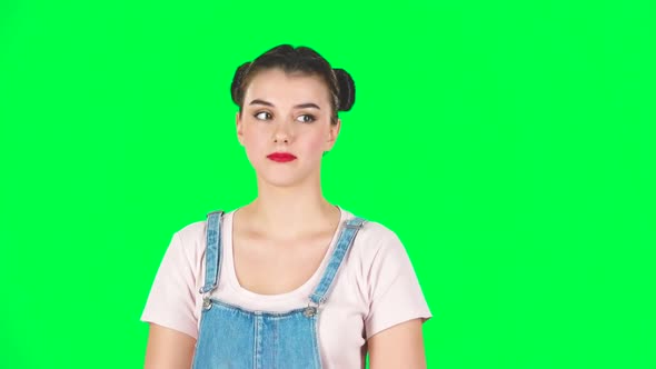 Playful Girl Funny Coquetting and Blowing a Kiss on Green Screen, Slow Motion