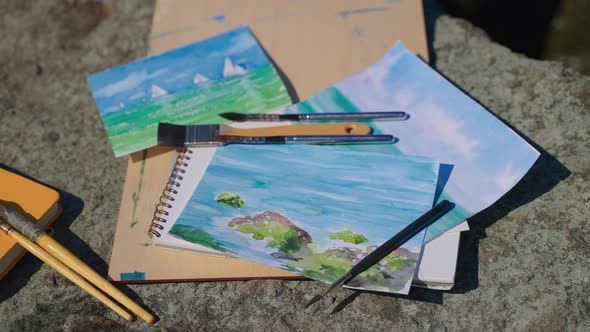 Finished Watercolor Seascapes and Brushes Outdoor
