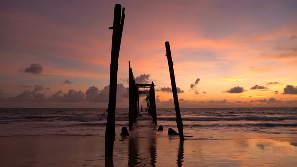 The old wooden bridge and sea wave on the beach at Khao Pilai, Phangnga, Thailand.