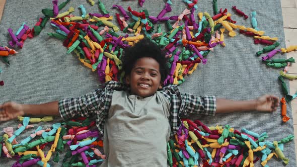 Boy Making Snow Angel in Candies