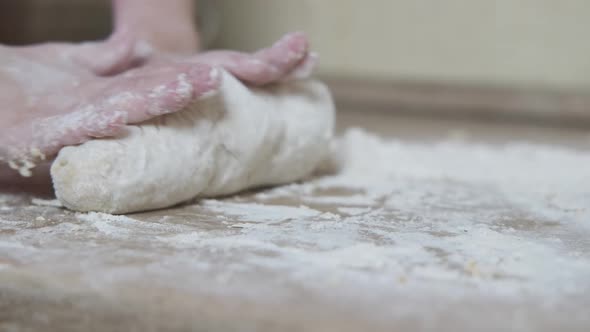 Hands of the child knead the dough.
