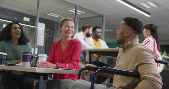 Happy diverse male and female business colleagues working in office