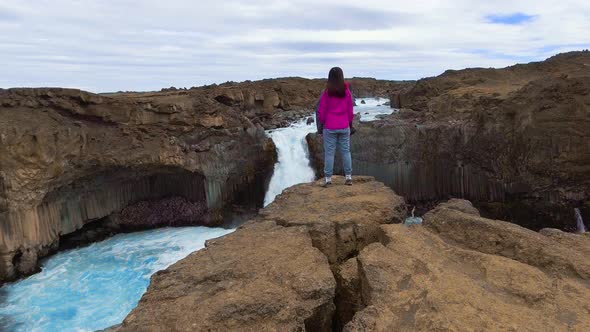 Traveler Hiking at Aldeyjarfoss Waterfall in Iceland