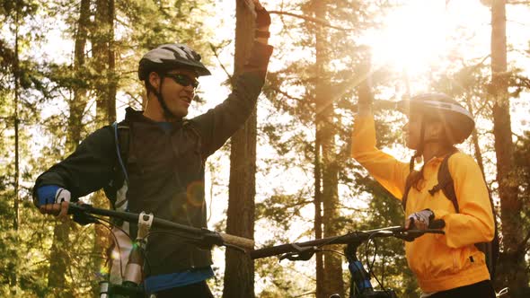 Mountain biking couple giving high five