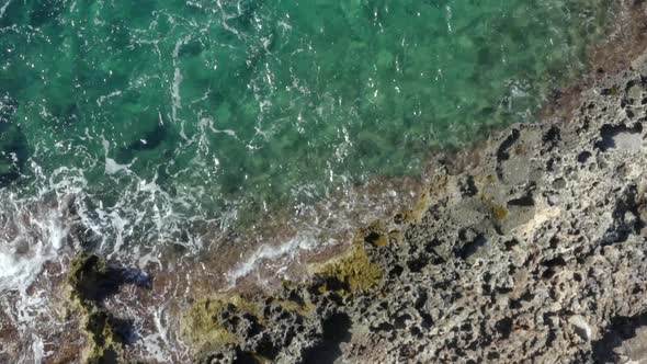AERIAL: Birds View of Beautiful Ocean Blue Water on Rock Coast on Tropical Island Mallorca, Spain