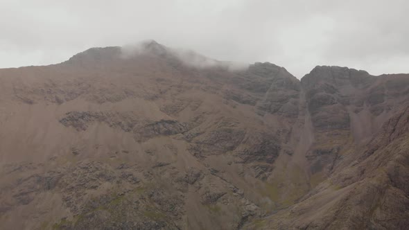 Drone shot turning to the right in mountain landscape in isle of skye highlands scotland, Cloudy day