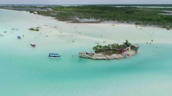 Amazing Green Island in the Middle Turquoise Milky Ocean Water with Boats Around