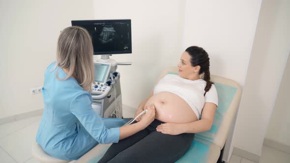 Doctor Doing Screening of Pregnant Woman with Ultrasound