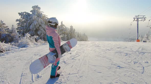 Girl Snowboarder with Snowboard on Mountain Top on Ski Resort