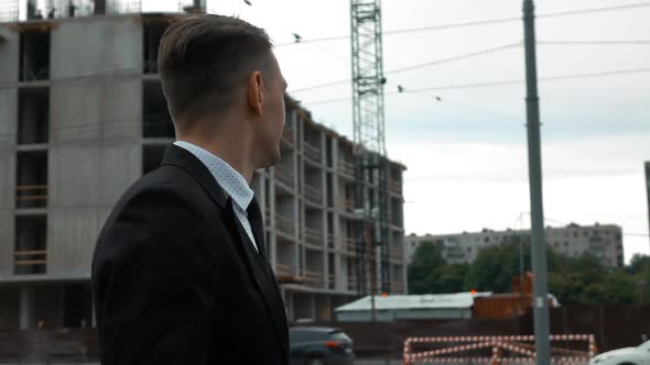 Businessman Walking Near Construction