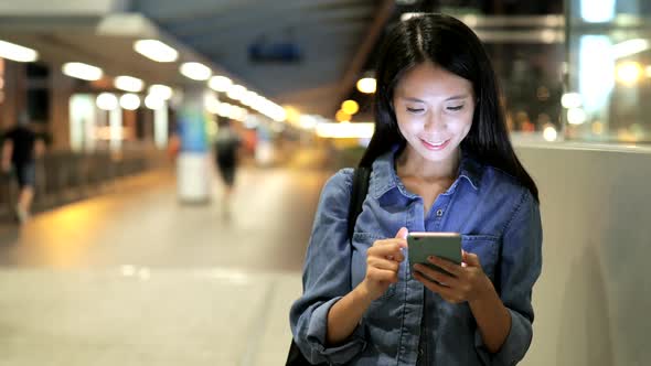 Young Woman Use of Smart Phone in City 