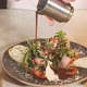 Close Up Hand of Chef Pours Sauce Over a Vegetarian Seafood Salad - VideoHive Item for Sale