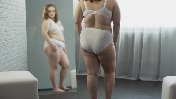 Plump Girl With Excess Weight Checking Skin, Looking for Cellulite on Body